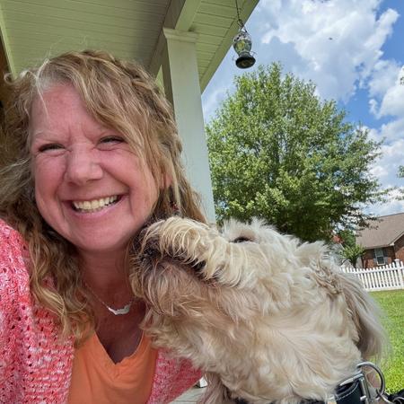 Sanibel pet sitter Lori with a fluffy white dog.